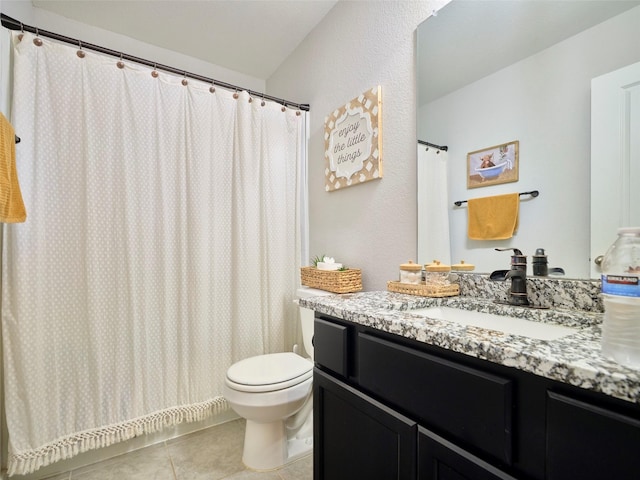 bathroom with tile patterned flooring, vanity, and toilet