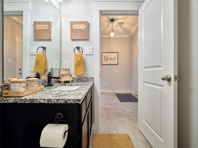 bathroom featuring tile patterned floors, vanity, and vaulted ceiling