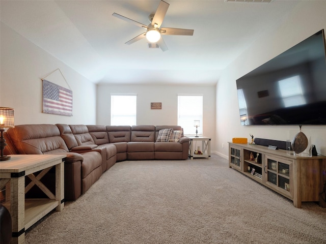 carpeted living room with ceiling fan and lofted ceiling