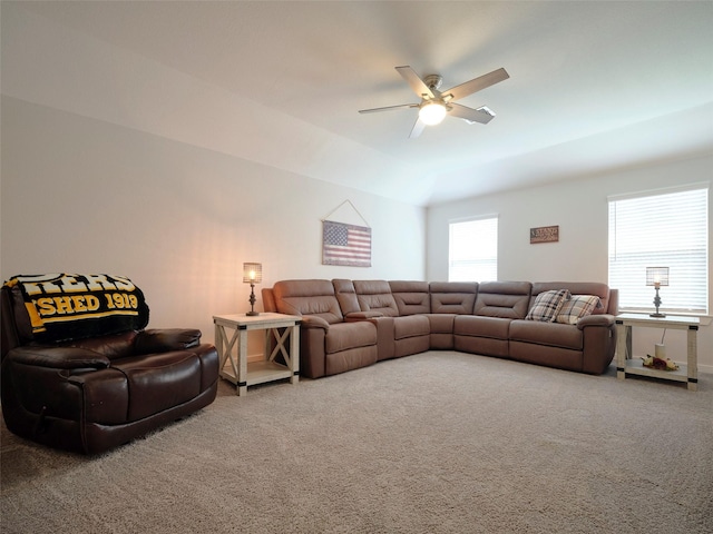 carpeted living room featuring ceiling fan and lofted ceiling