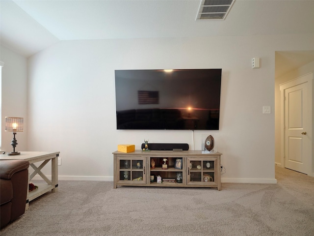 carpeted living room with lofted ceiling