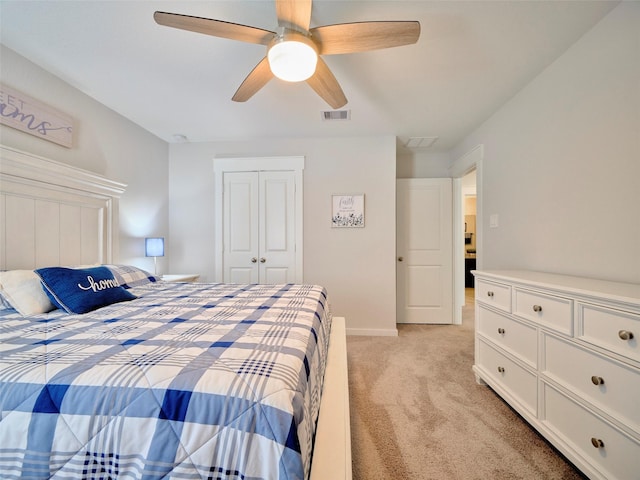 carpeted bedroom with ceiling fan and a closet