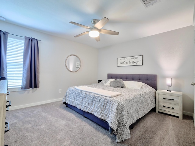 carpeted bedroom with ceiling fan and multiple windows