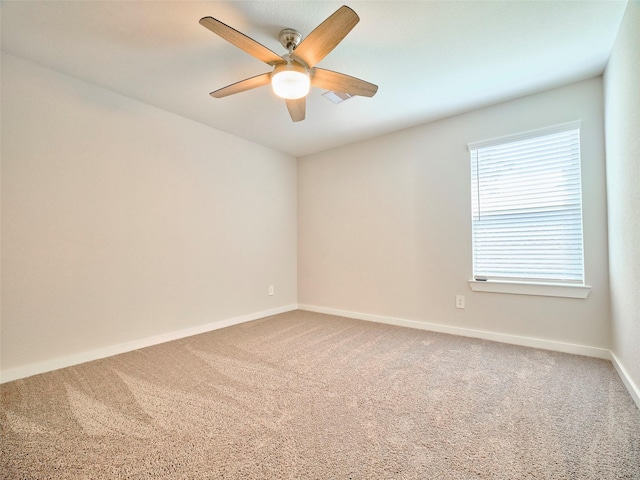 carpeted empty room featuring ceiling fan