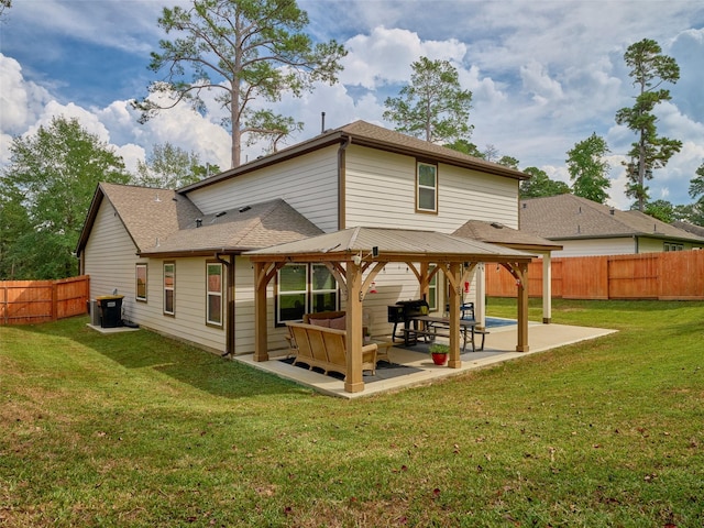 rear view of house with outdoor lounge area, a patio area, and a yard