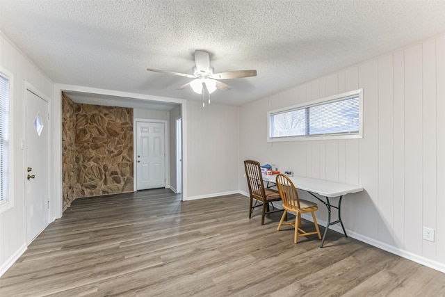 office space featuring ceiling fan, hardwood / wood-style flooring, and a textured ceiling