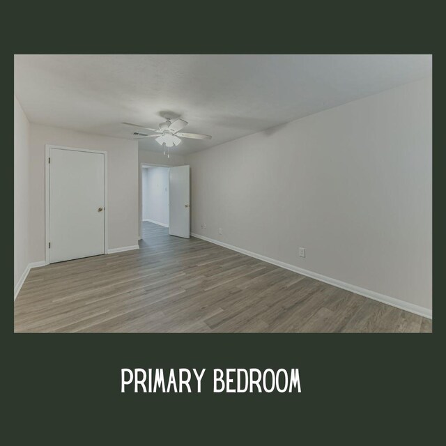 empty room featuring ceiling fan and light hardwood / wood-style floors