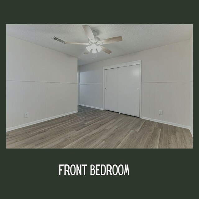 unfurnished bedroom with ceiling fan, light hardwood / wood-style floors, and a textured ceiling