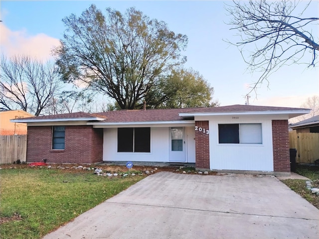 ranch-style house with a lawn