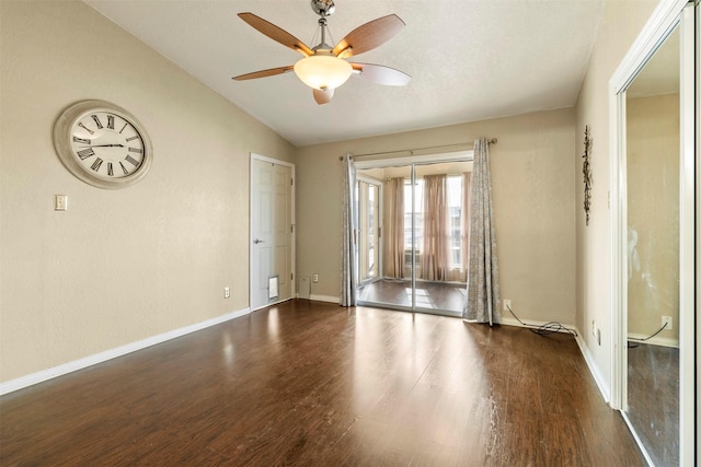 unfurnished room featuring ceiling fan, dark hardwood / wood-style flooring, and lofted ceiling