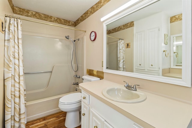 full bathroom featuring vanity, hardwood / wood-style floors, shower / bathtub combination with curtain, and toilet