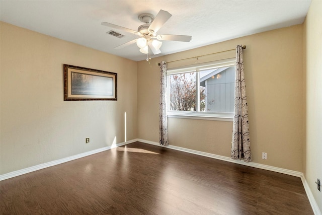 spare room with ceiling fan and dark hardwood / wood-style flooring