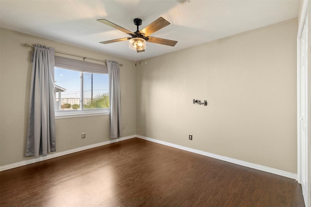 empty room featuring ceiling fan and dark hardwood / wood-style floors