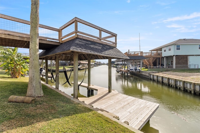 dock area featuring a lawn and a water view