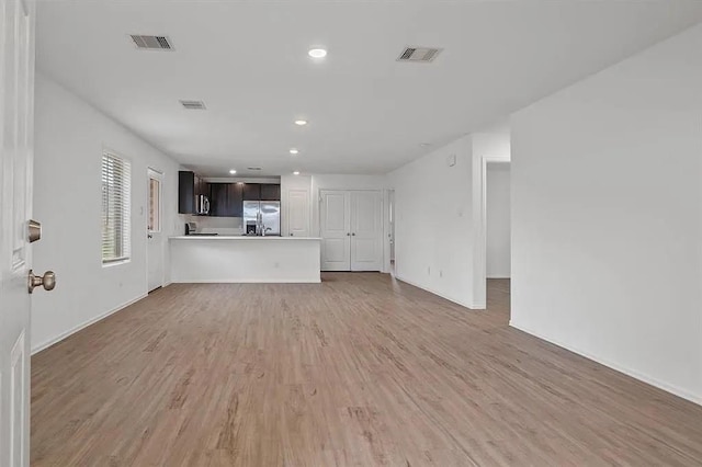 unfurnished living room with light hardwood / wood-style floors