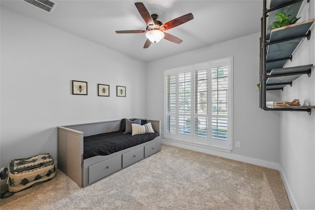 sitting room with ceiling fan and light colored carpet