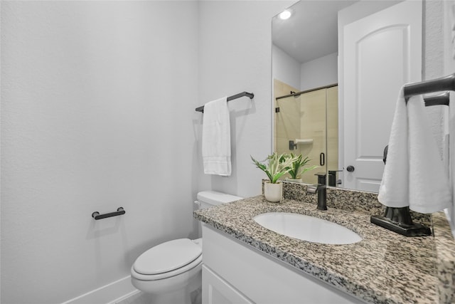 bathroom featuring vanity, toilet, and walk in shower