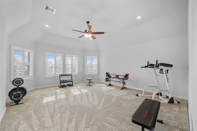 workout room with ceiling fan, light carpet, and vaulted ceiling