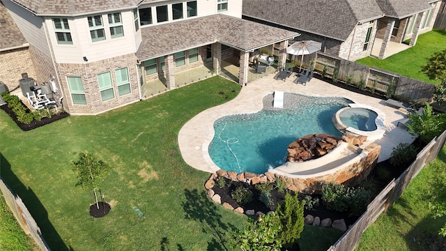 view of pool with a yard, an in ground hot tub, and a patio