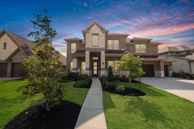 view of front of home with a garage and a lawn