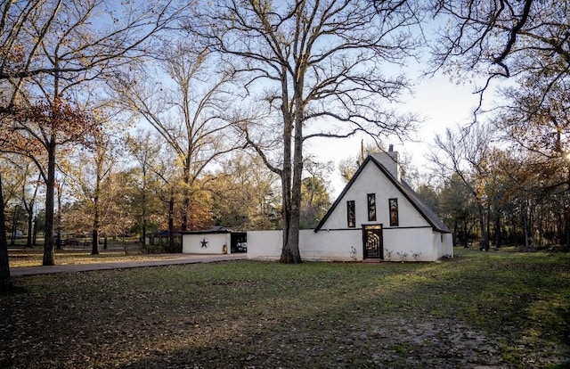 view of side of home featuring a lawn