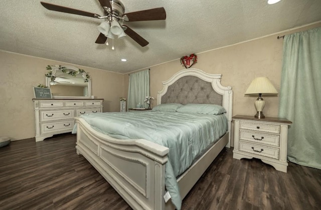 bedroom with a textured ceiling, ceiling fan, and dark wood-type flooring