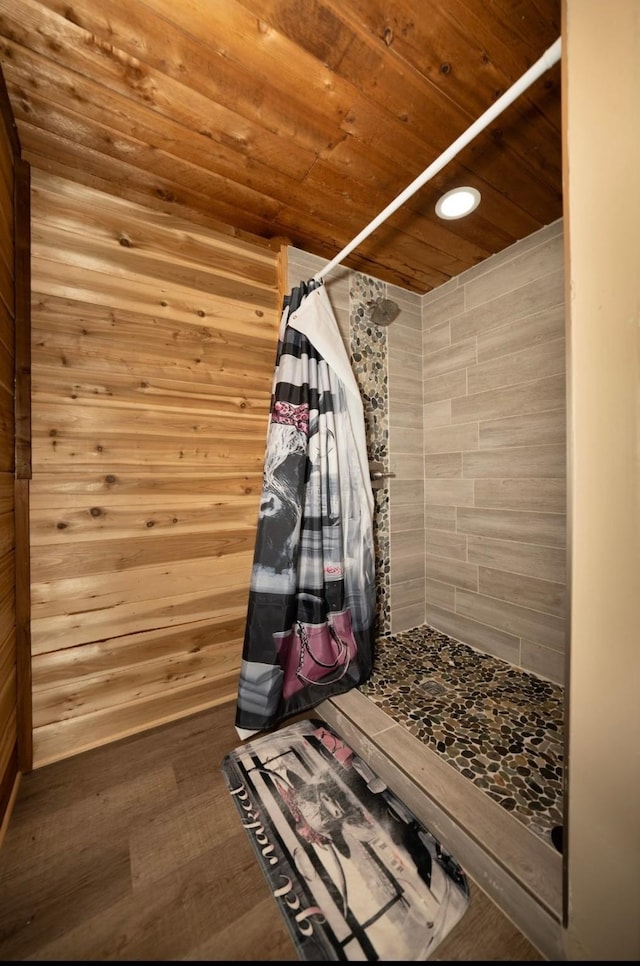 mudroom with hardwood / wood-style floors, wooden ceiling, and wooden walls