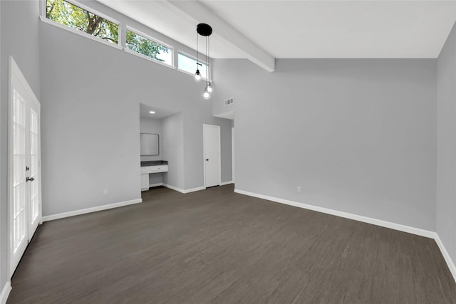 unfurnished living room featuring beamed ceiling, dark hardwood / wood-style floors, and high vaulted ceiling