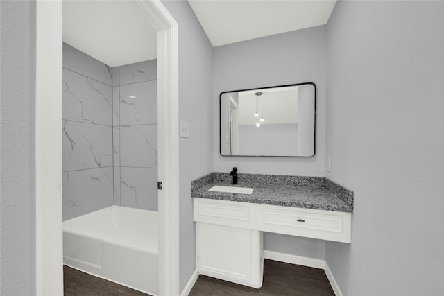 bathroom featuring tiled shower / bath, vanity, and hardwood / wood-style flooring