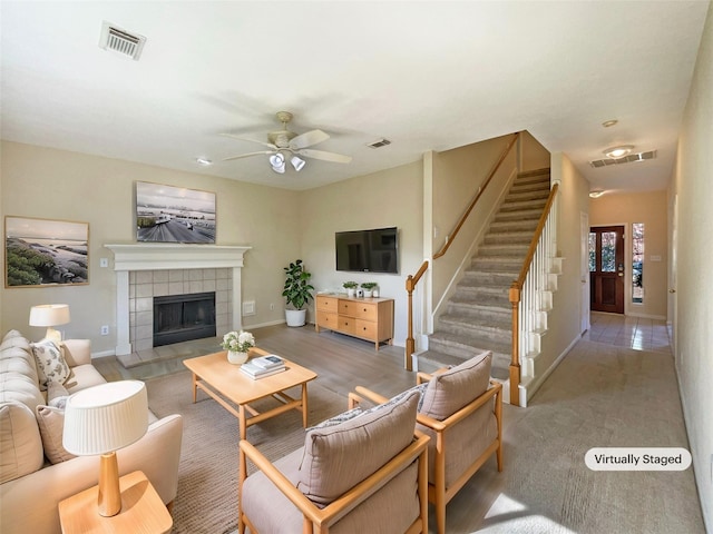 living room with a fireplace and ceiling fan