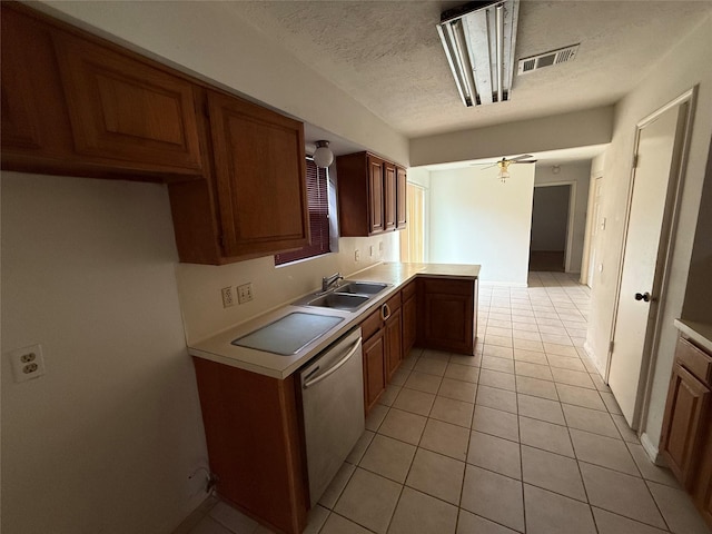 kitchen with ceiling fan, sink, stainless steel dishwasher, a textured ceiling, and light tile patterned flooring