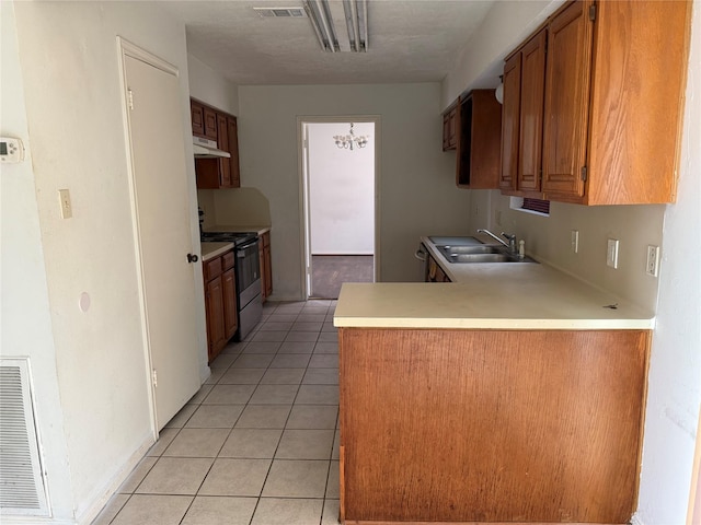 kitchen featuring kitchen peninsula, light tile patterned flooring, stainless steel electric range oven, and sink