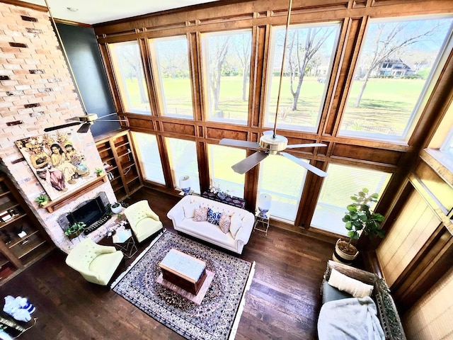 living room featuring ceiling fan and dark hardwood / wood-style flooring