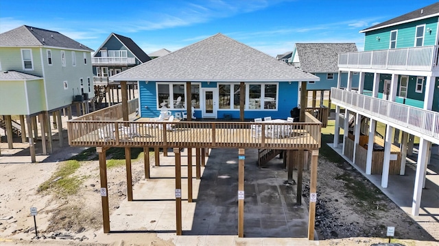 rear view of house featuring a deck