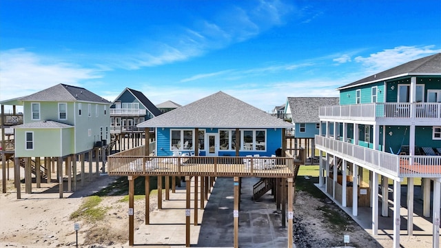 rear view of house featuring a carport and a deck