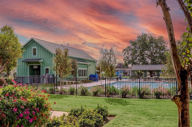 pool at dusk with a yard