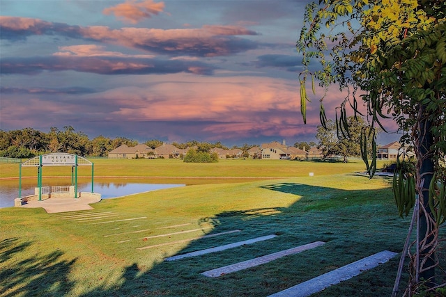 surrounding community featuring a water view and a yard