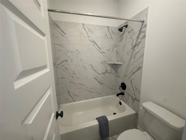 bathroom featuring toilet and tiled shower / bath