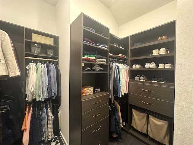 walk in closet featuring vaulted ceiling