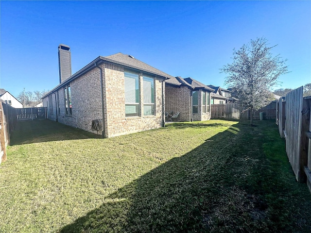 view of side of home with a lawn