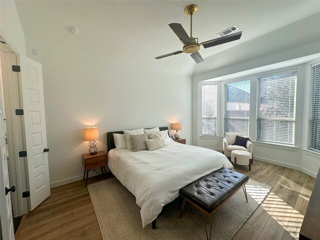 bedroom with vaulted ceiling, ceiling fan, and light hardwood / wood-style flooring