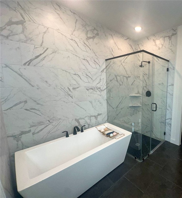 bathroom with tile walls, plus walk in shower, and tile patterned flooring