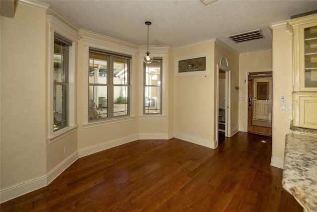 unfurnished dining area featuring ornamental molding and dark hardwood / wood-style flooring