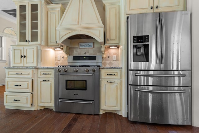 235 Fm 3313, Crockett, TX 75835 - kitchen with stainless steel appliances, cream cabinets, premium range hood, light stone counters, and dark wood finished floors