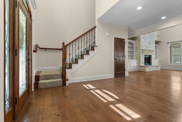 235 Fm 3313, Crockett, TX 75835 - unfurnished living room featuring crown molding, wood finished floors, stairway, a stone fireplace, and recessed lighting
