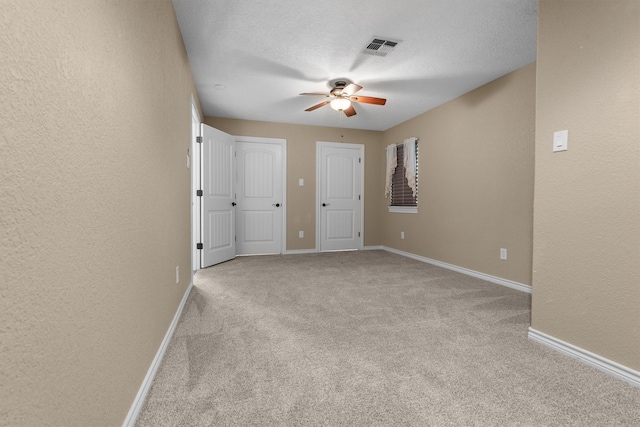 235 Fm 3313, Crockett, TX 75835 - unfurnished bedroom featuring carpet floors, a textured wall, and a ceiling fan