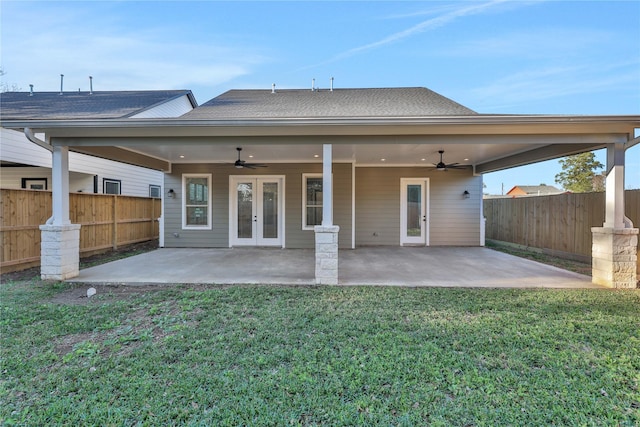 rear view of house with french doors, a yard, and a patio area