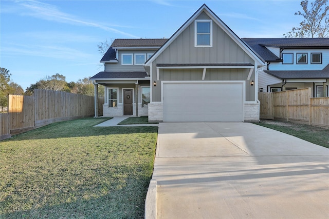 view of front of property with a front yard and a garage