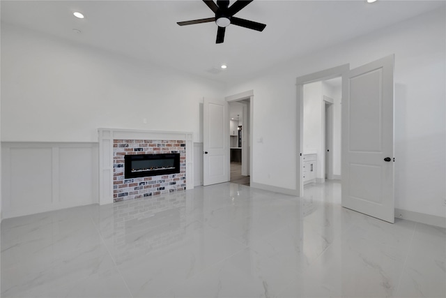 unfurnished living room featuring a fireplace and ceiling fan