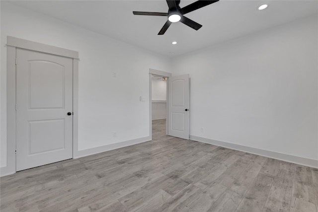 empty room featuring light wood-type flooring and ceiling fan